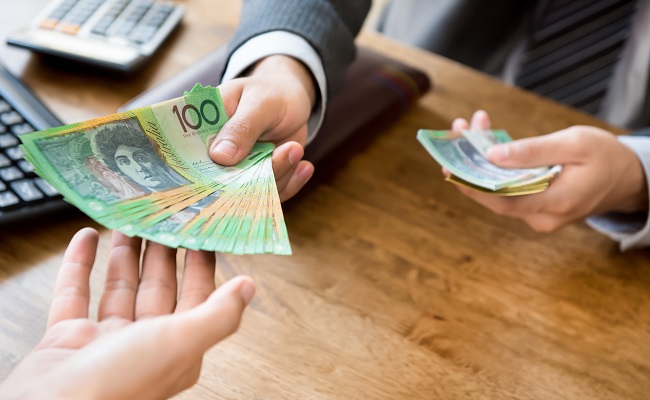 businessmanasanemployerpayingcashaustraliandollarmoneyto