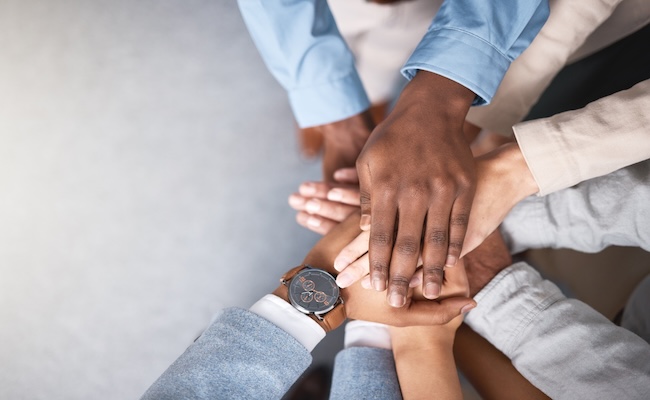 businesspeoplehandsstackandsupportaboveforcollaborationand