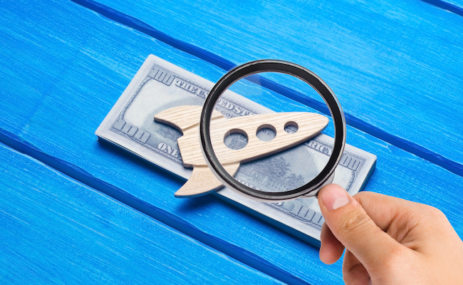 awoodenfigurineofarocketonapackof