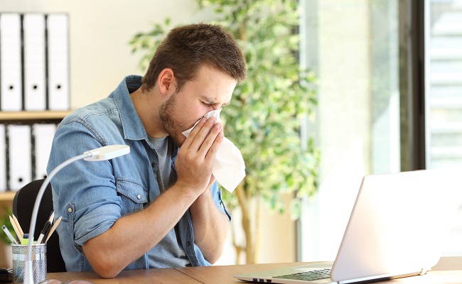 sideviewofanillentrepreneursneezinginawipe