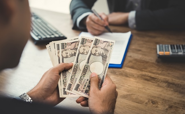 businessmancountingmoneyjapaneseyencurrencywhilemakingcontractagreement